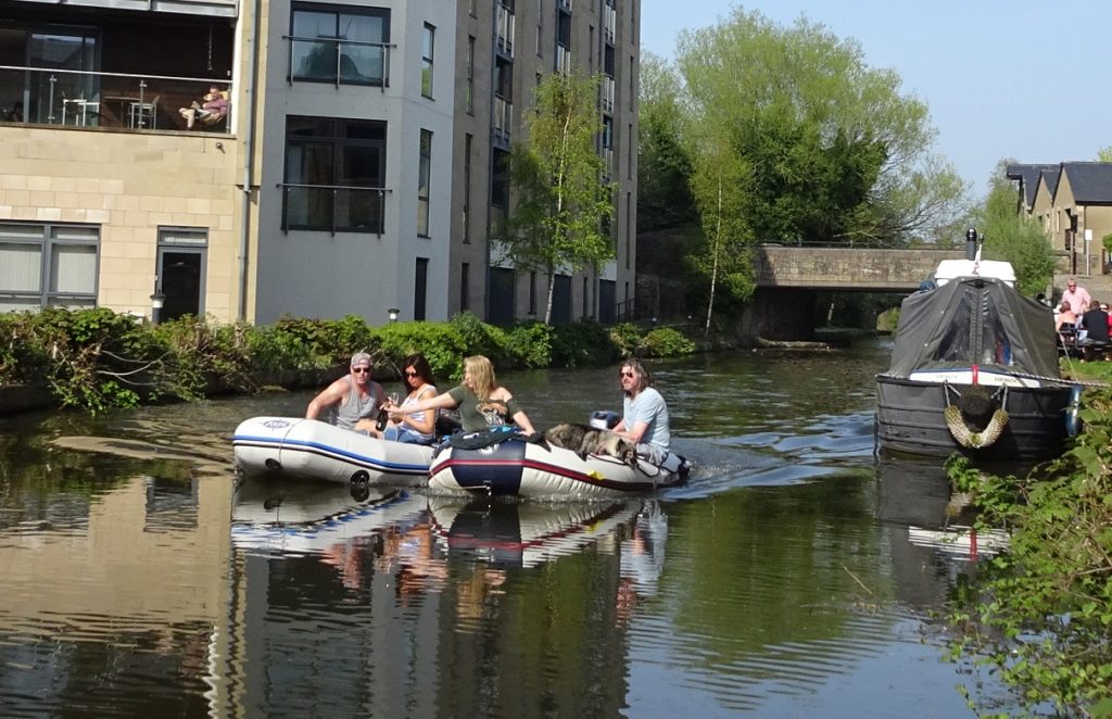 Canal neds sharing wine from boat to boat