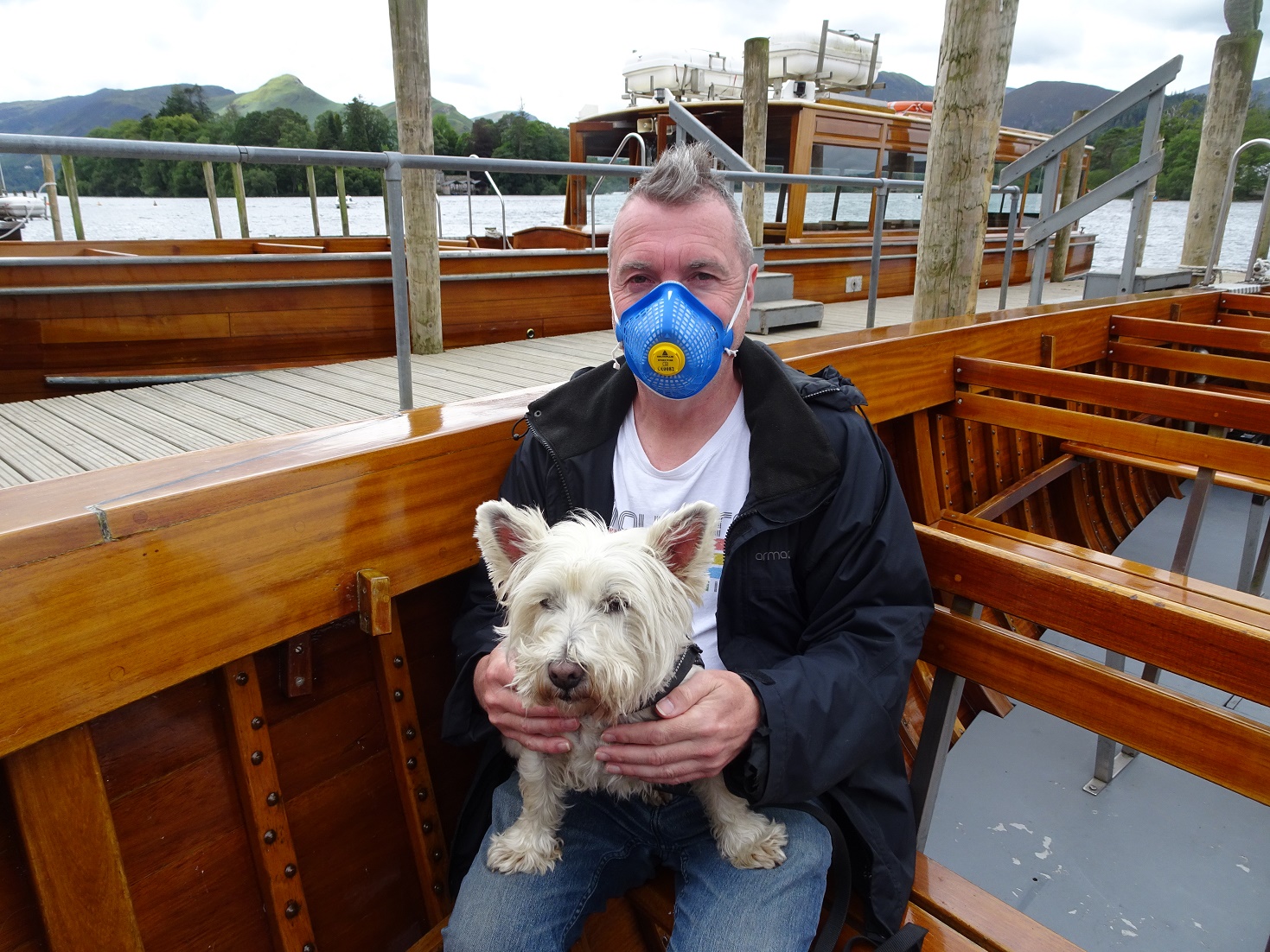 poppy the westie with dad wearing a muzzle