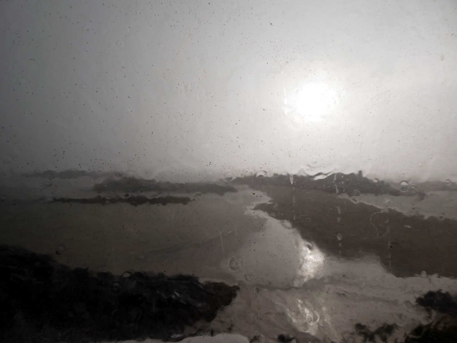 rainy view of eigg from inside the van